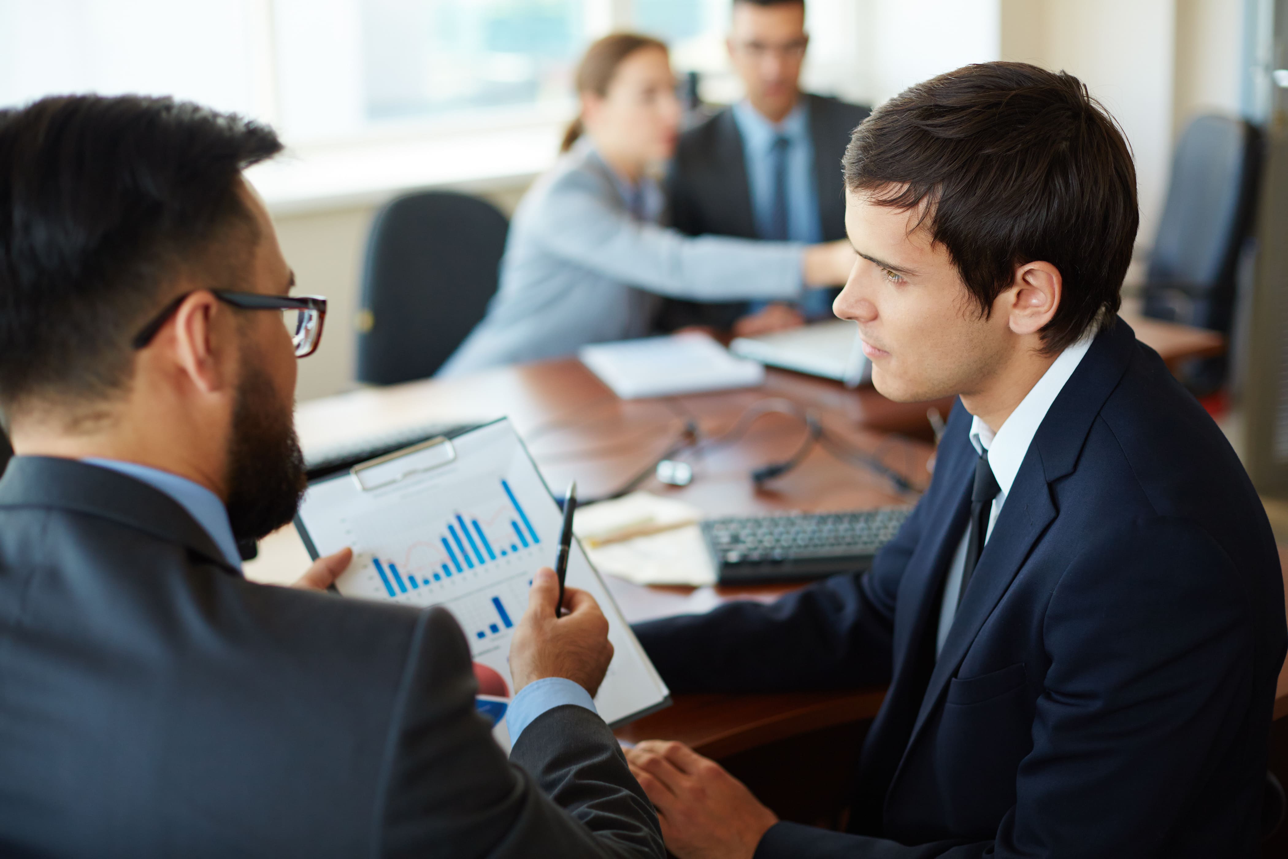 HR specialist reviewing workforce analytics and bar graph reports