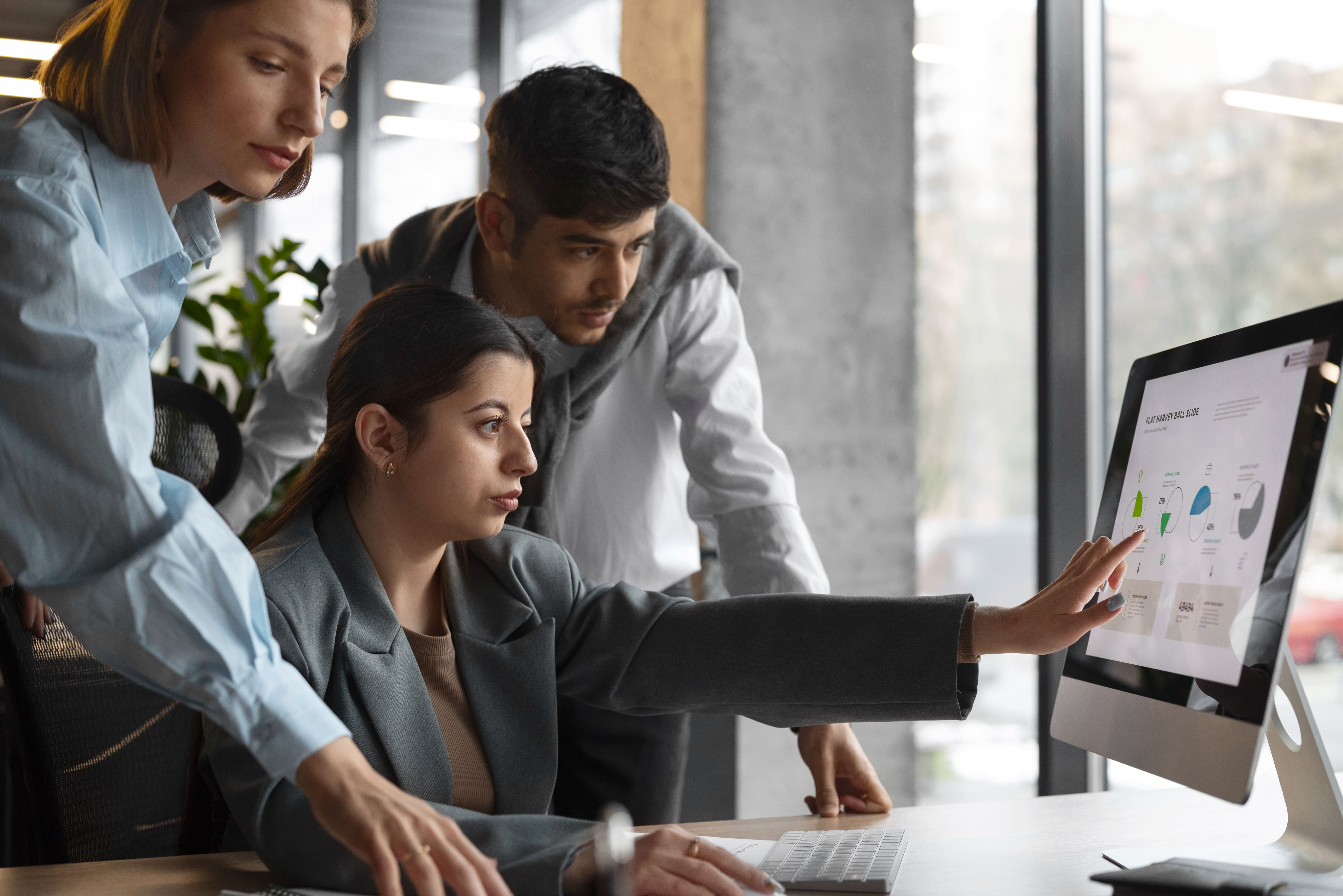 Team reviewing HR analytics and business reports on a desktop screen